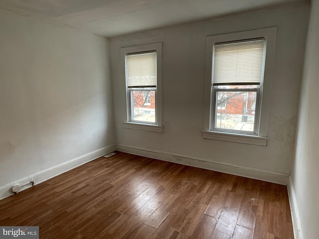 spare room with dark hardwood / wood-style flooring