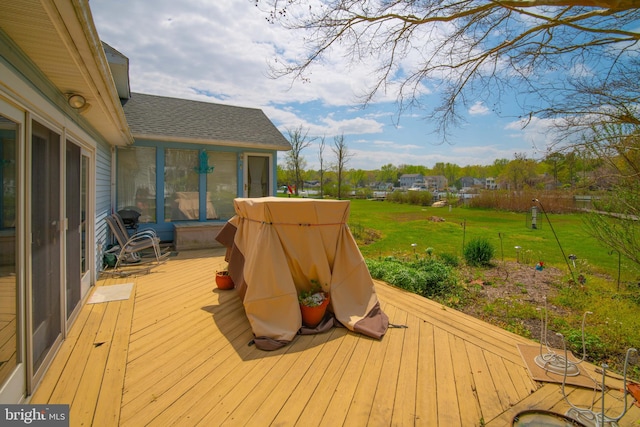 wooden deck featuring a yard