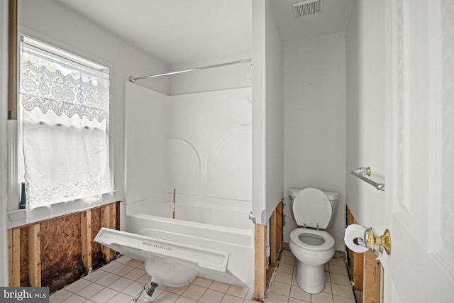 bathroom with tile floors,  shower combination, and toilet