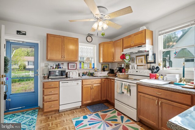 kitchen featuring light parquet floors, white appliances, and ceiling fan