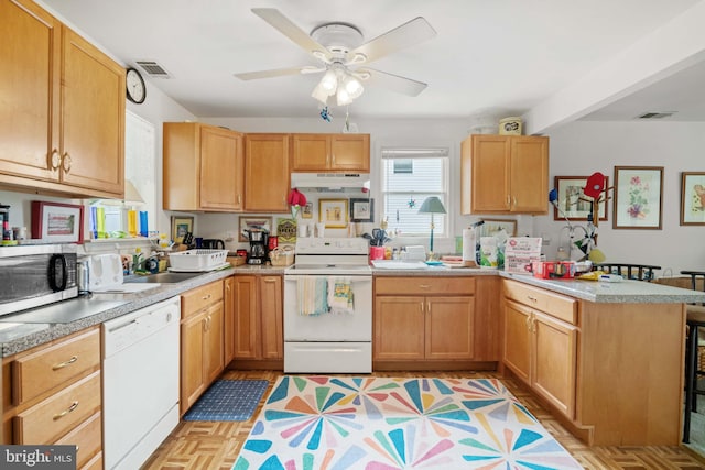 kitchen with ceiling fan, white appliances, light parquet flooring, and kitchen peninsula