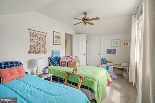 carpeted bedroom with ceiling fan and vaulted ceiling