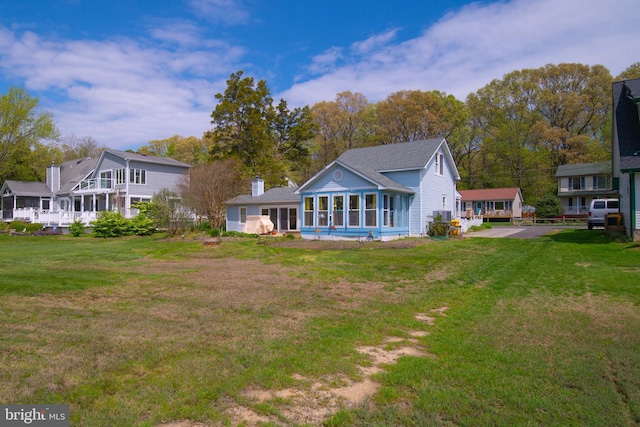 rear view of house with a yard