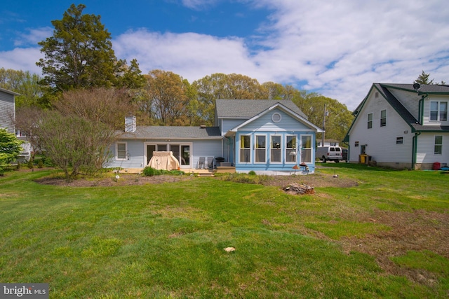 rear view of house with a yard