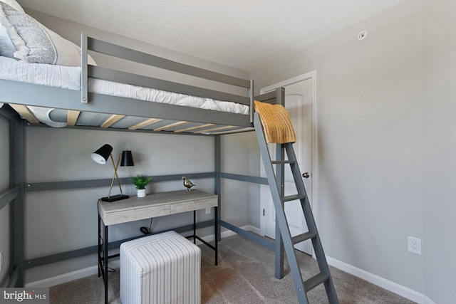 bedroom with dark colored carpet