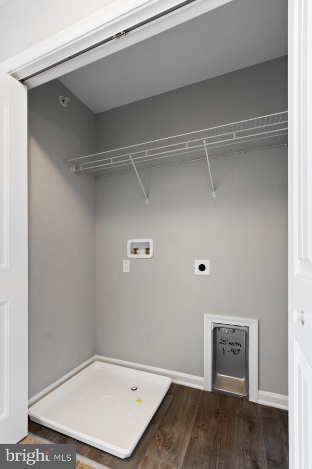 clothes washing area with dark hardwood / wood-style flooring, hookup for an electric dryer, and washer hookup