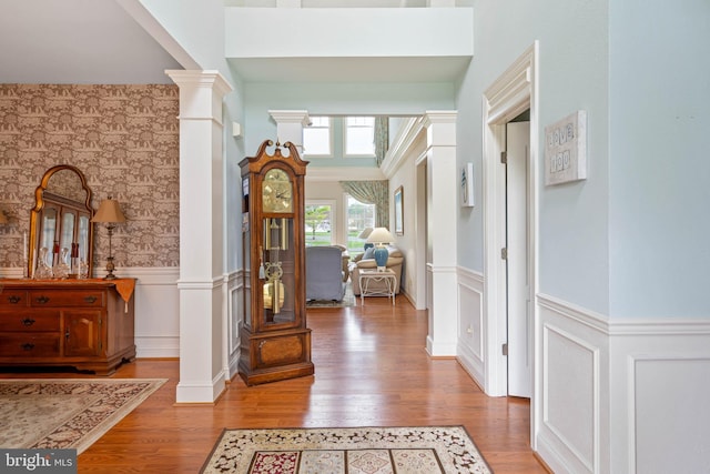 entryway featuring hardwood / wood-style flooring and ornate columns