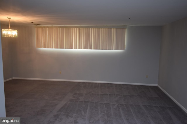 empty room featuring dark carpet