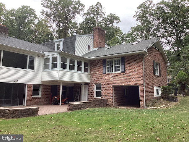 back of property with a patio and a lawn