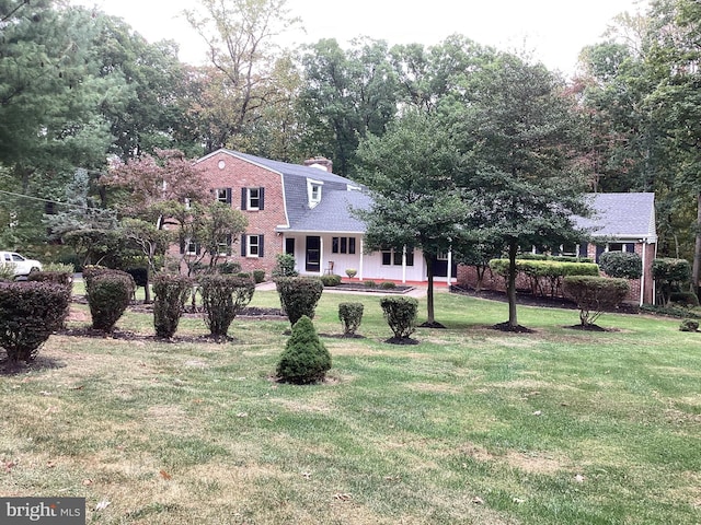 view of front of property with a front yard and covered porch