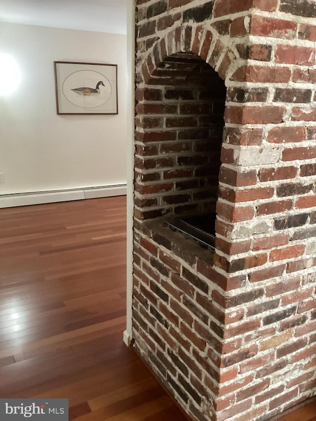 room details featuring hardwood / wood-style flooring and a baseboard radiator