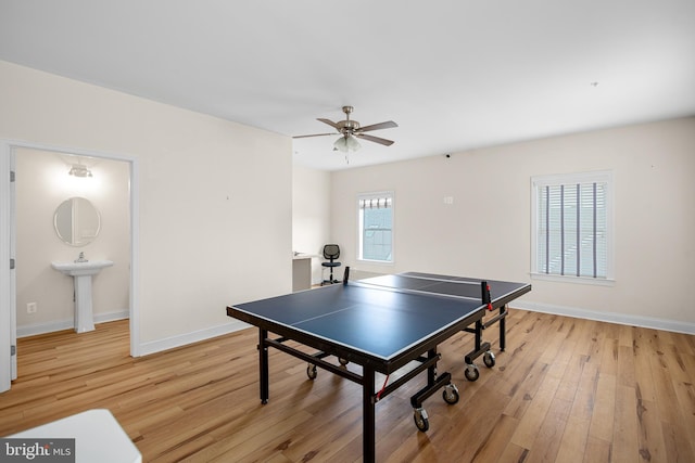 game room featuring sink, light hardwood / wood-style flooring, and ceiling fan