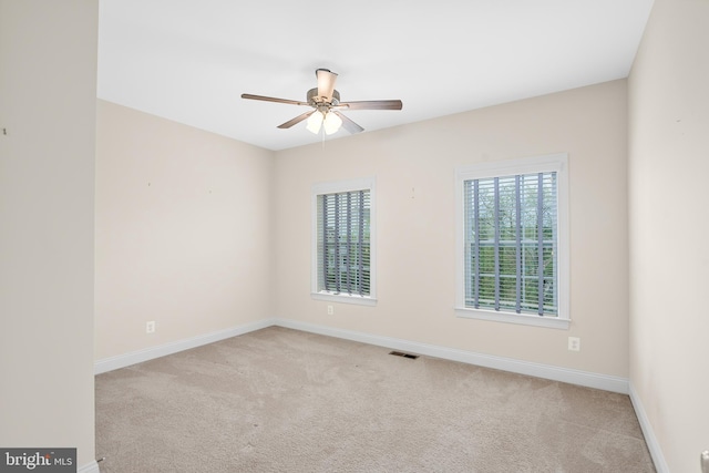 carpeted empty room featuring ceiling fan