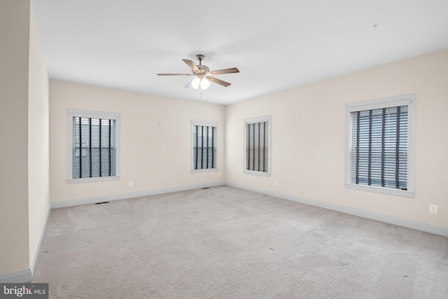 carpeted empty room featuring ceiling fan