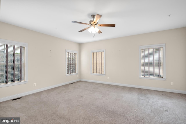 carpeted empty room featuring ceiling fan