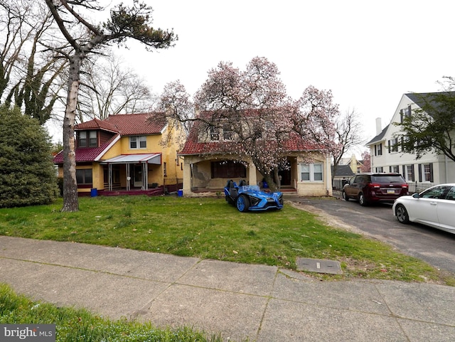 mediterranean / spanish-style home with a front yard