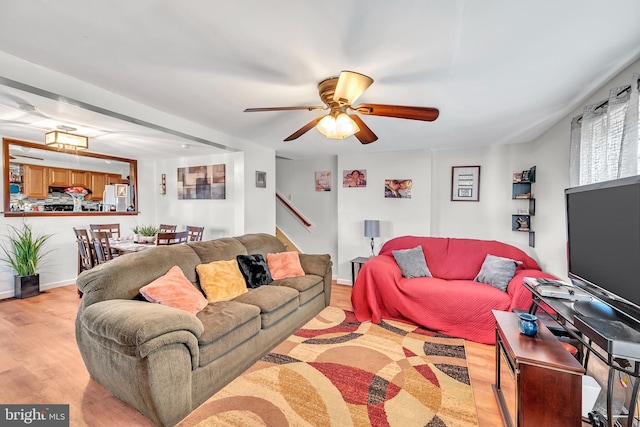 living room featuring light hardwood / wood-style floors and ceiling fan