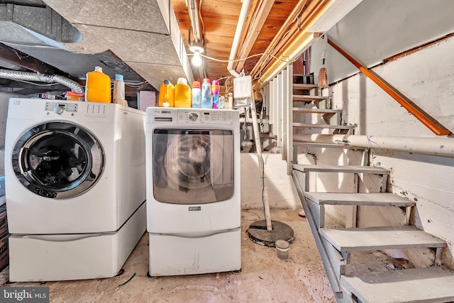 clothes washing area with washer and clothes dryer