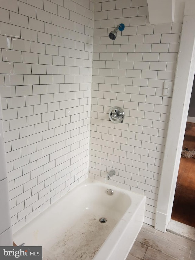 bathroom featuring hardwood / wood-style flooring and tiled shower / bath