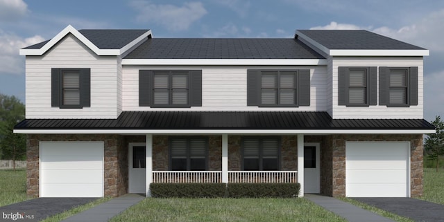 view of property with a garage and covered porch