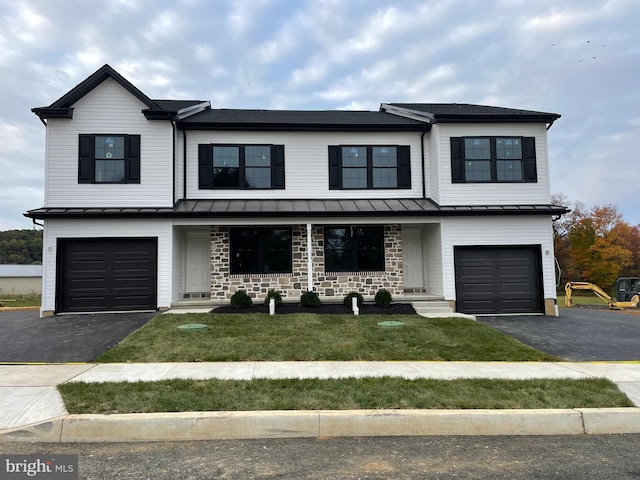 view of front of house with a garage and a front lawn