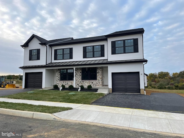 view of front of home with a front yard and a garage