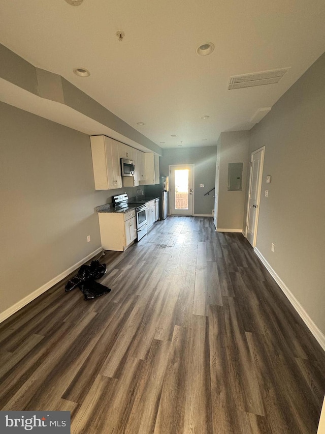 unfurnished living room featuring dark wood-type flooring