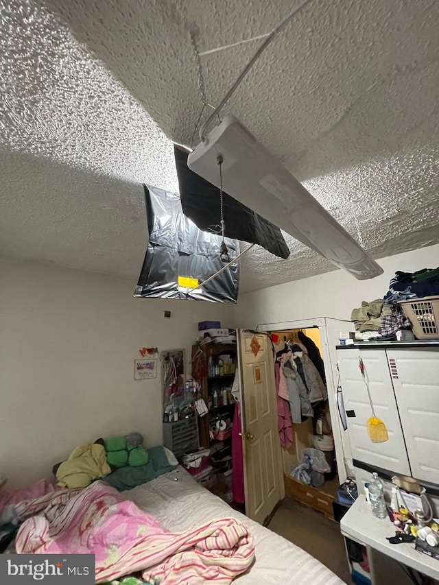 bedroom featuring a closet and a textured ceiling