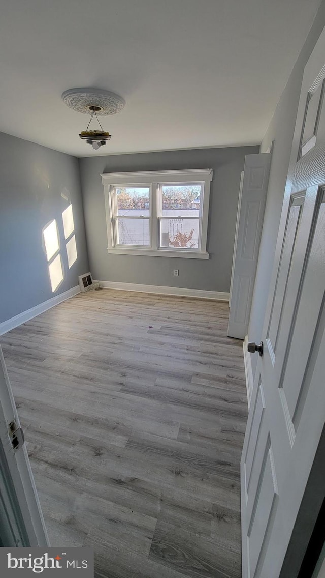 spare room with hardwood / wood-style flooring