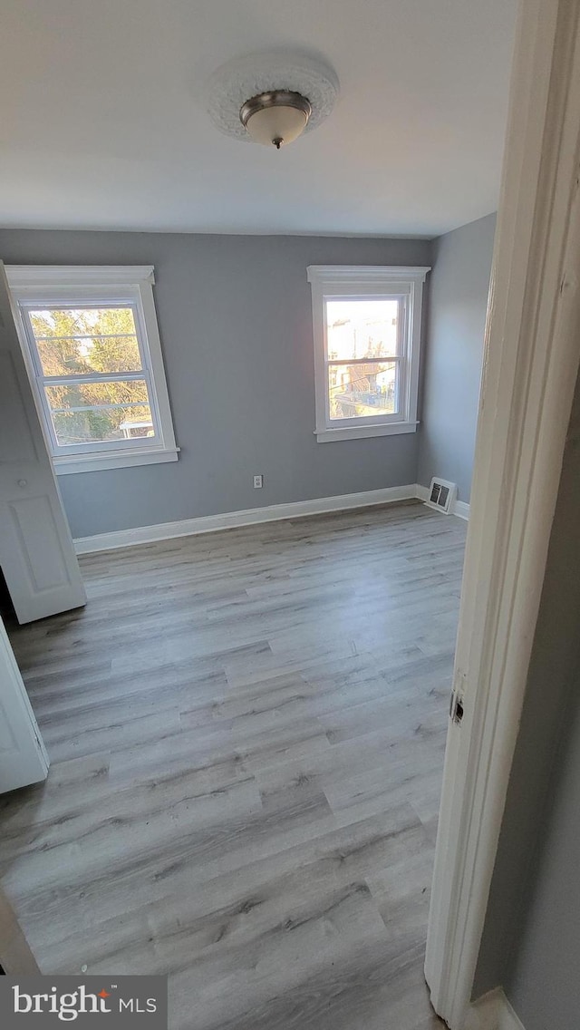 spare room with light hardwood / wood-style floors