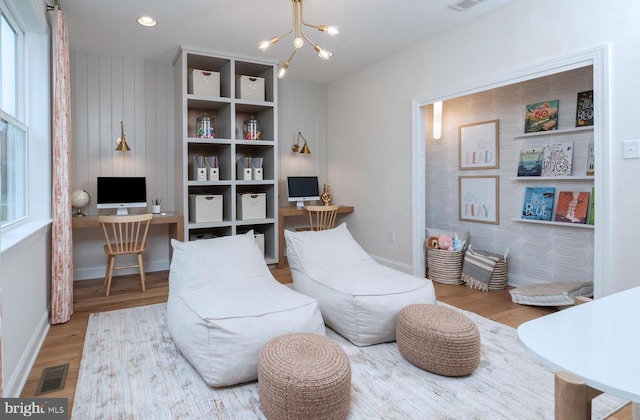 sitting room featuring light hardwood / wood-style flooring and a notable chandelier