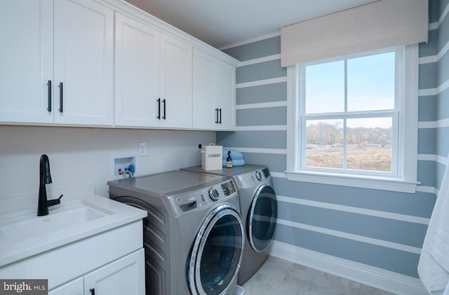 laundry room with hookup for a washing machine, cabinets, sink, and washer and dryer