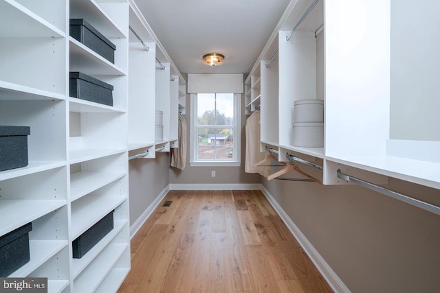 spacious closet featuring light hardwood / wood-style floors