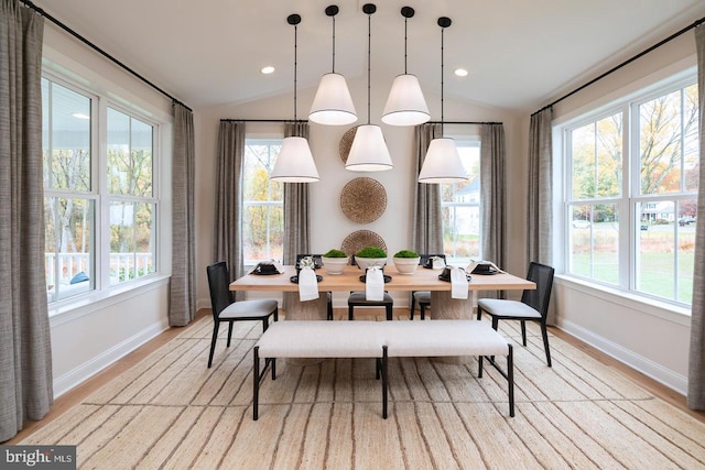 dining room featuring a wealth of natural light, light hardwood / wood-style floors, and lofted ceiling