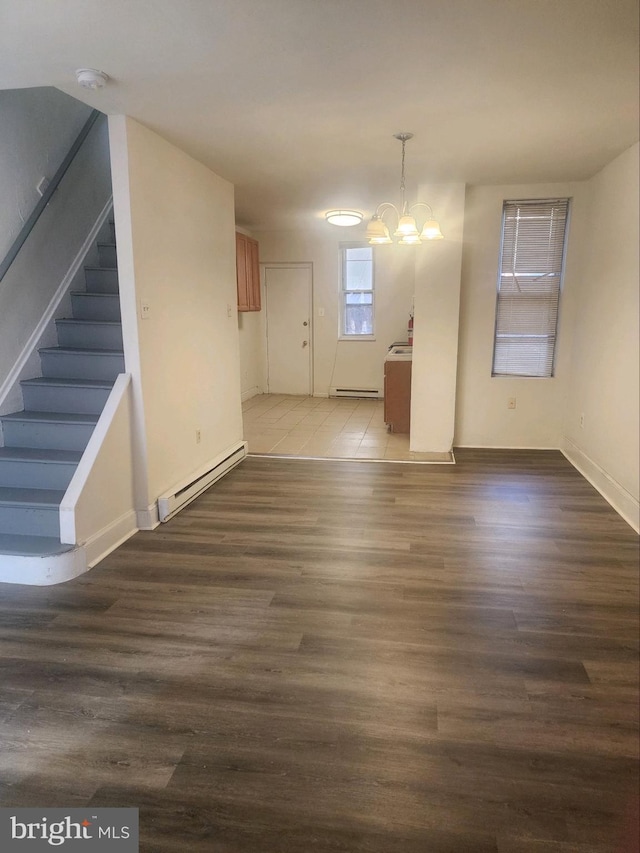 unfurnished room with a baseboard radiator, a chandelier, and tile flooring