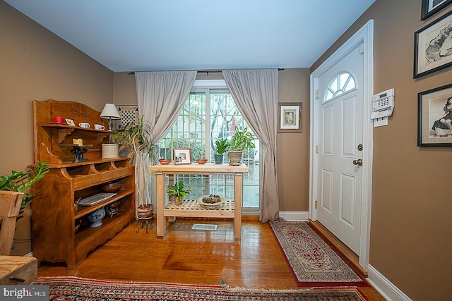 foyer with dark hardwood / wood-style floors