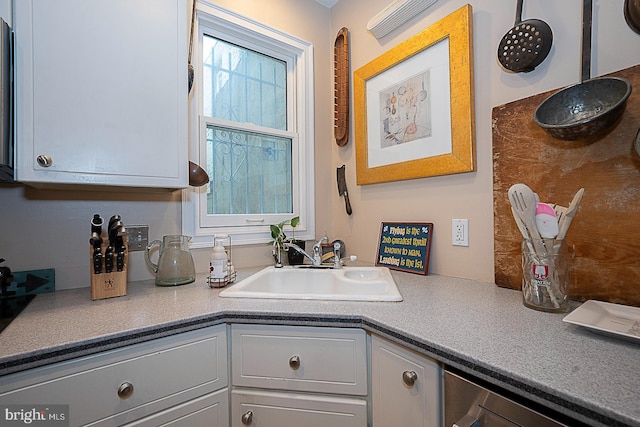 kitchen featuring sink and white cabinetry