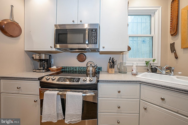 kitchen with white cabinets, sink, and stainless steel appliances