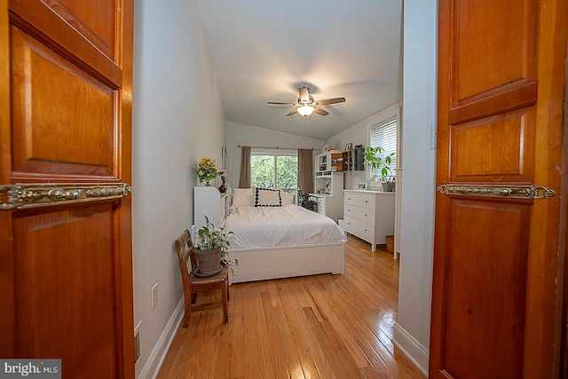 bedroom featuring vaulted ceiling, light hardwood / wood-style floors, and ceiling fan