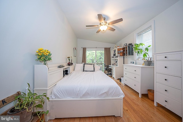 bedroom with lofted ceiling, light hardwood / wood-style flooring, and ceiling fan