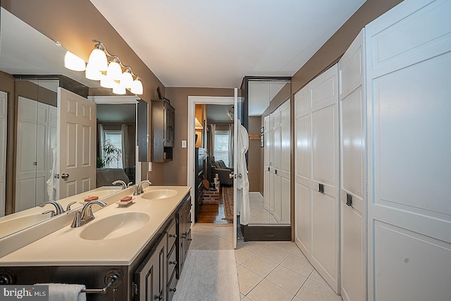 bathroom featuring dual sinks, tile flooring, and large vanity