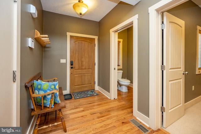 foyer entrance with light hardwood / wood-style flooring