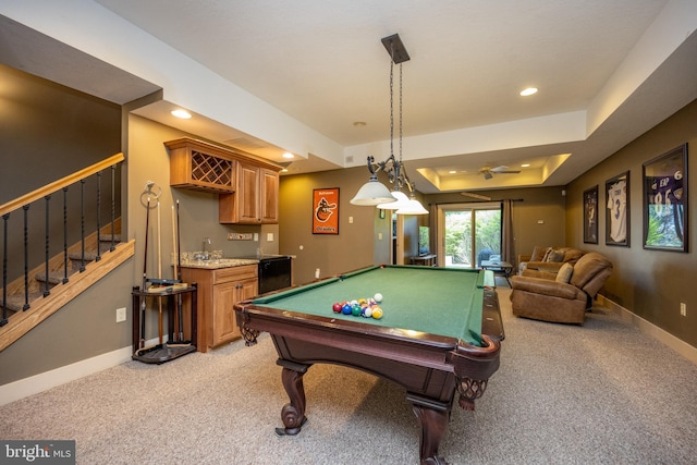 game room featuring light carpet, a tray ceiling, and billiards