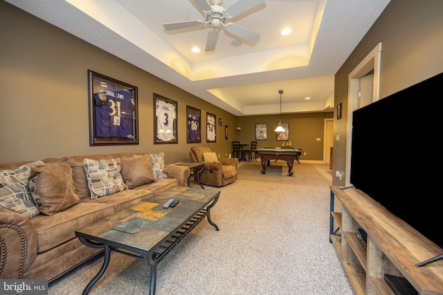 living room with billiards, ceiling fan, a raised ceiling, and carpet flooring