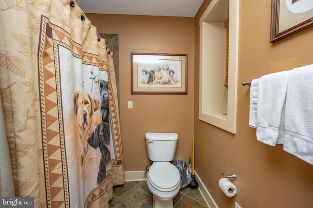 bathroom featuring tile floors and toilet