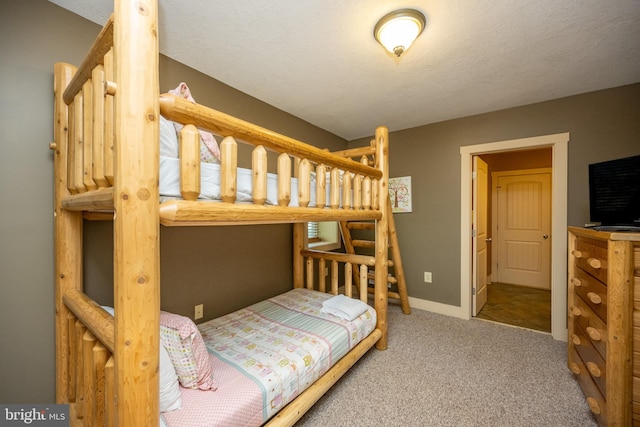 carpeted bedroom with a textured ceiling