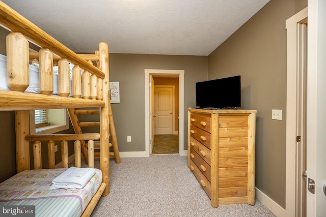 bedroom with a textured ceiling and carpet floors