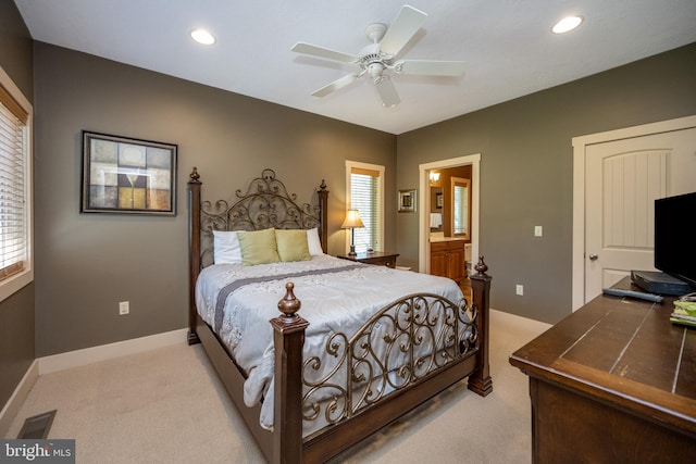 bedroom with connected bathroom, ceiling fan, and carpet floors