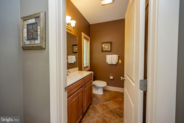 bathroom featuring tile floors, toilet, and oversized vanity