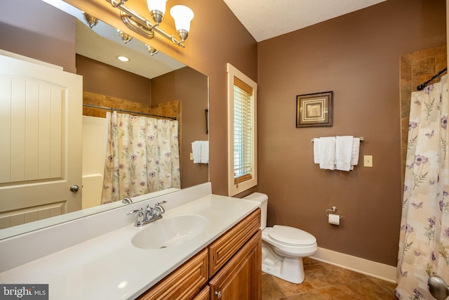 bathroom featuring toilet, tile flooring, and large vanity